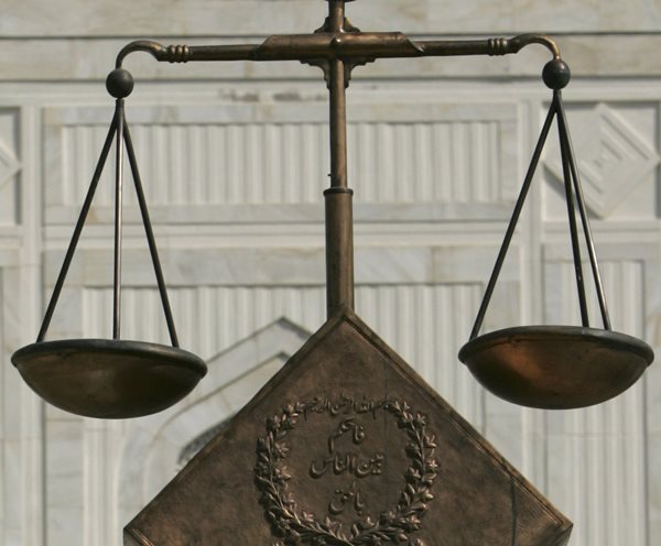 the scales of justice weighing equally before a white background