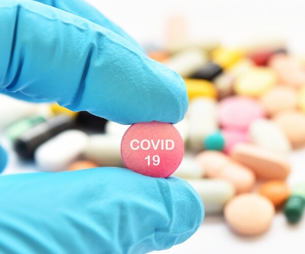 COVID-19 written on a pill