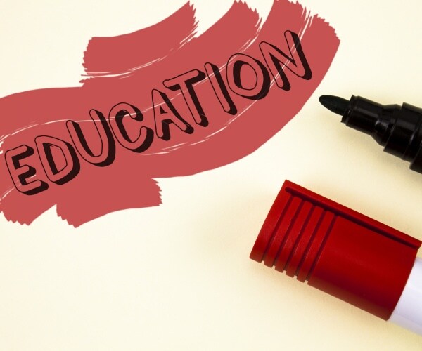 education word in red and black with markers to the right