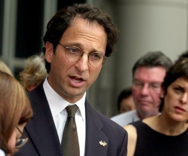 andrew weissmann wearing a suit and white shirt and glasses in a crowd of people