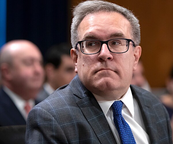 andrew wheeler looks back over his right shoulder