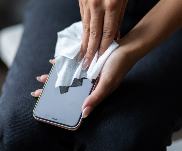 a woman cleaning her cellphone
