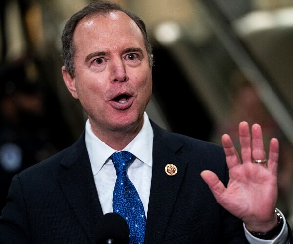 adam schiff holds up hand