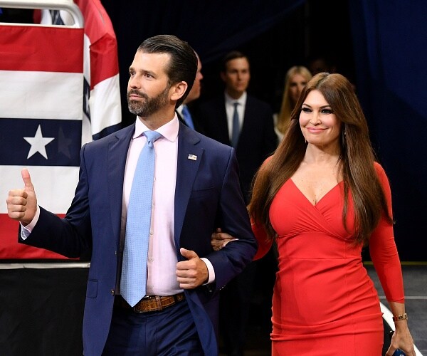 donald trump jr and kimberly guilfoyle walk into amway center