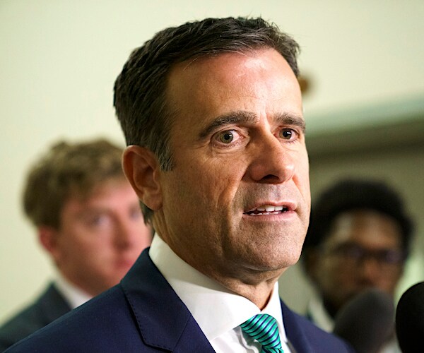 john ratcliffe looks to the right as he addresses the media during a news conference