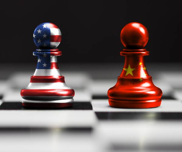 pawns on a chess board with american and chinese flags painted on them