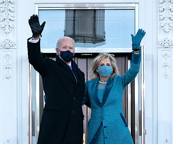 president joe biden and first lady jill biden wave from the white house front steps