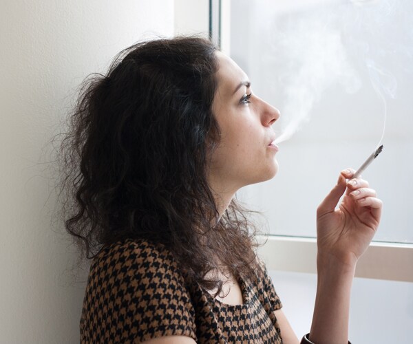 a woman smoking a cigarette