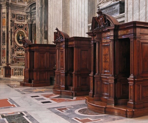 confession booths in wood with italian religious art in background