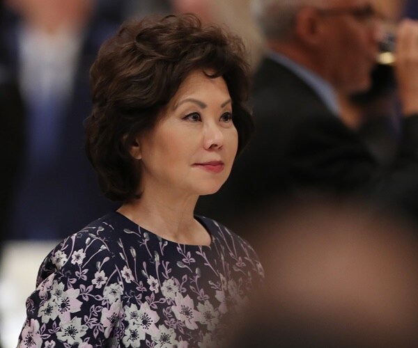 sec. elaine chao sits at a table at a state event