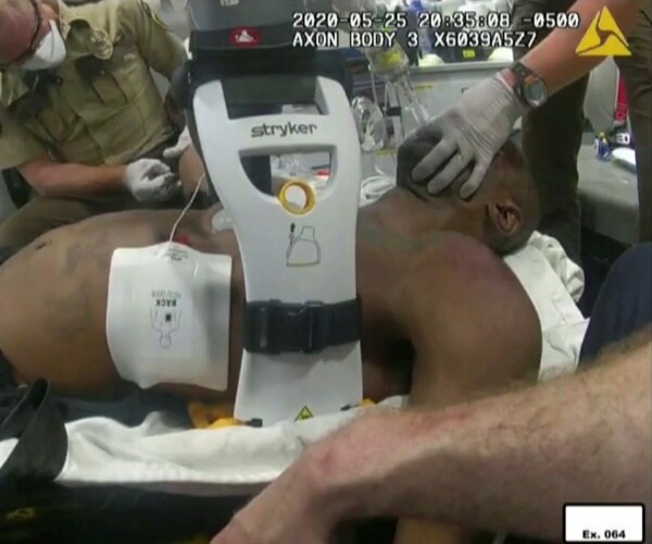 Emergency workers tend to George Floyd after he had been loaded into an ambulance on May 25, 2020, in Minneapolis.