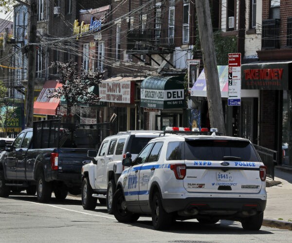 a nypd cruiser is seen parked in front of buildings
