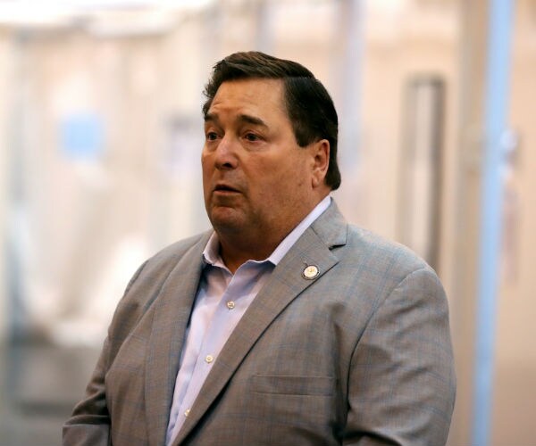Louisiana Lt. Governor Billy Nungesser speaks to the media in a tan suit with blue pinstripes