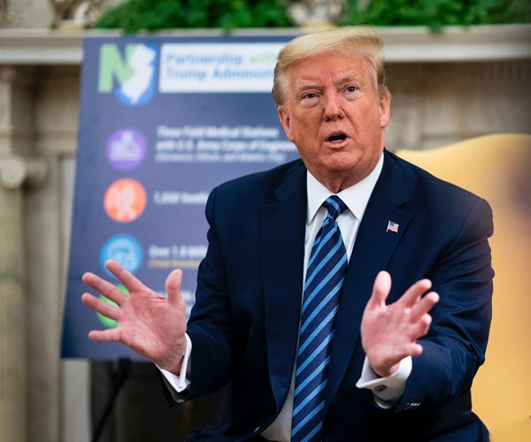 president donald trump gestures during a meeting in the oval office