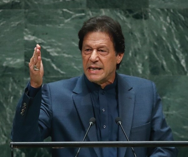 Imran Khan speaks at a lectern.