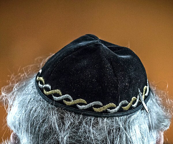 a jewish kippa on the head of a gray haired jewish american