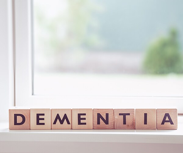 wooden tiles on a window ledge that spell out DEMENTIA.