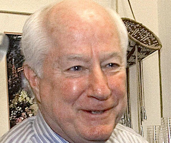 jim kolbe smiles during a session with the media