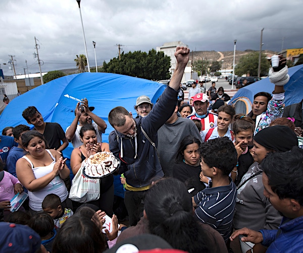 a group of migrants at the southern border get together to protest the trump administration's border policies