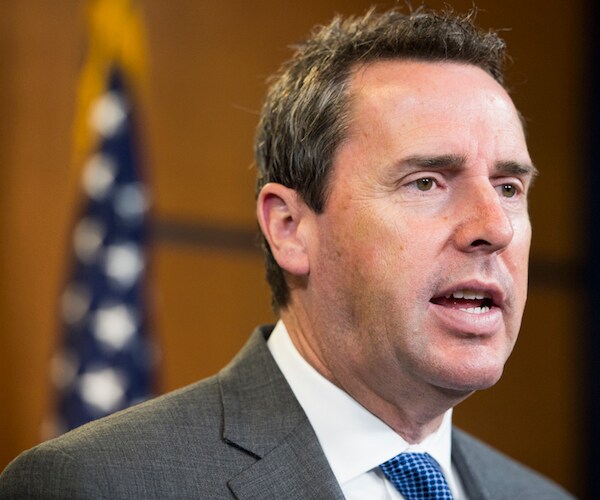 mark walker stands and addresses the media