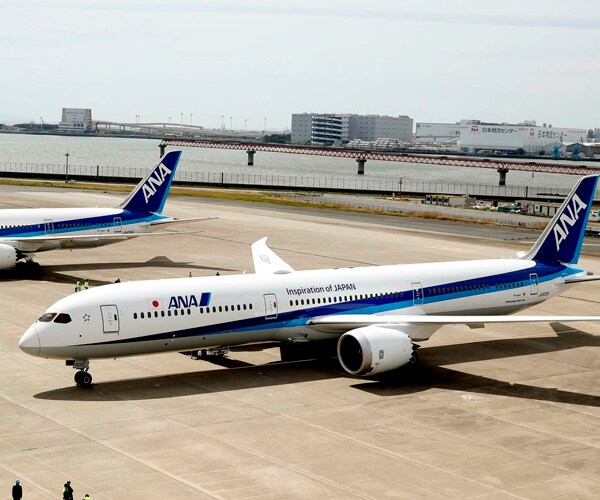 two all nippon airways boeing 787-10 planes sit on a tarmac