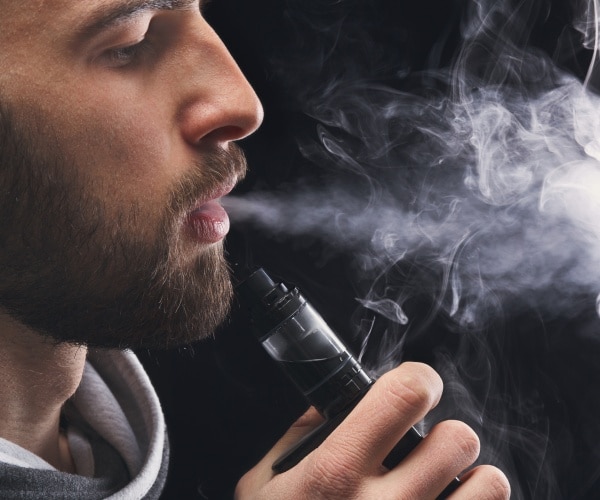man smoking e-cigarette