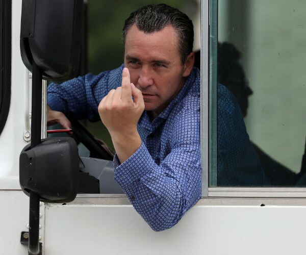 pastor tony spell is shown leaning out of a bus