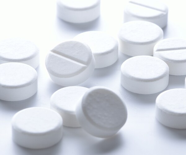 white aspirin pills on a table