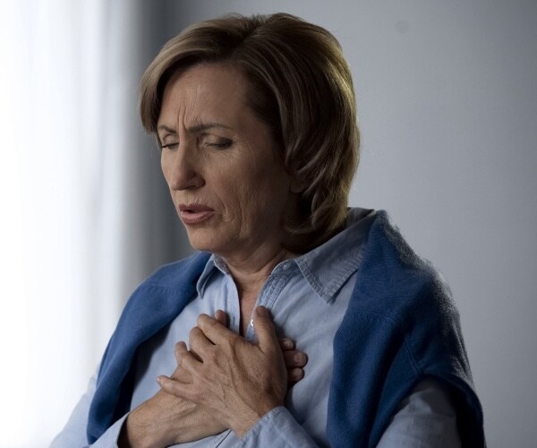 older woman having trouble breathing due to asthma