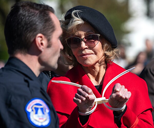 Actress Jane Fonda gestures after being arrested during a rally on Capitol Hill in Washington on Friday