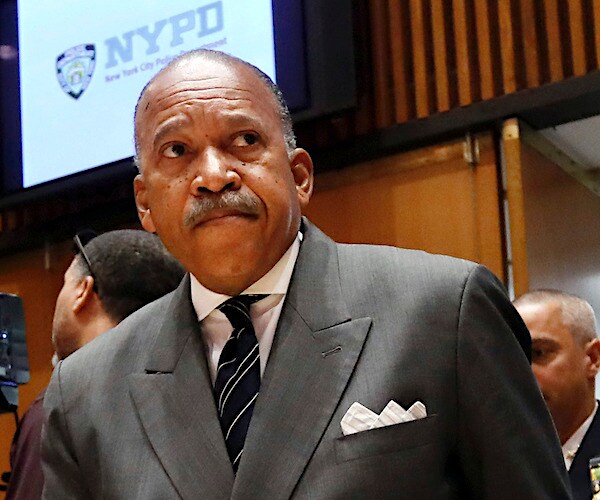 Benjamin Tucker, a black man who is No. 2 in the en why pee dee, arrives for a news conference at headquarters