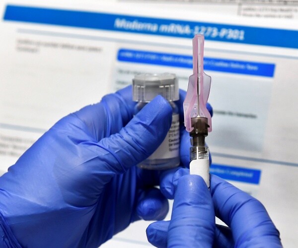 nurse prepares syringe