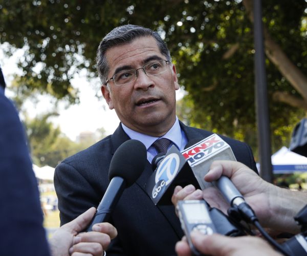 california attorney general xavier becerra talks to reporters.