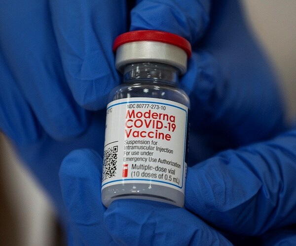 michelle chester holds coronavirus vaccine