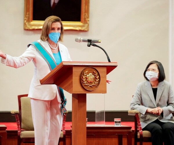nancy pelosi gestures while speaking