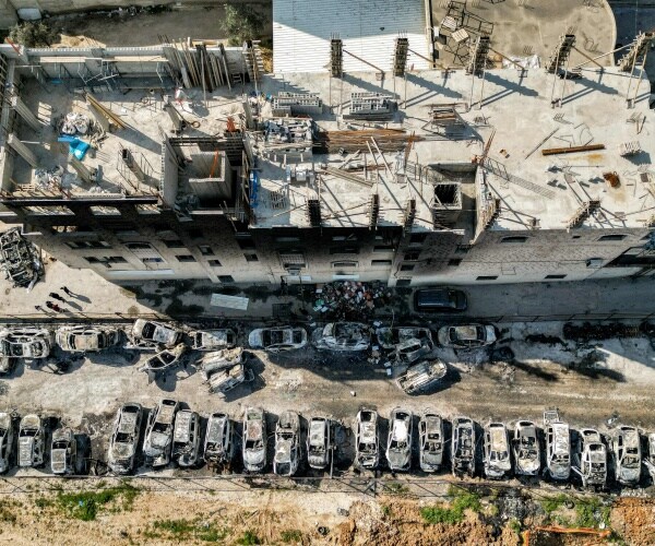 a view of a scrapyard where cars were torched