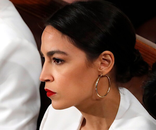 Rep. Alexandria Ocasio-Cortez, D-N.Y., sits with a scowl as watches the state of the union address
