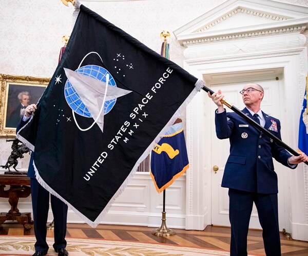 the space force flag is held up, looking very much like star trek logo