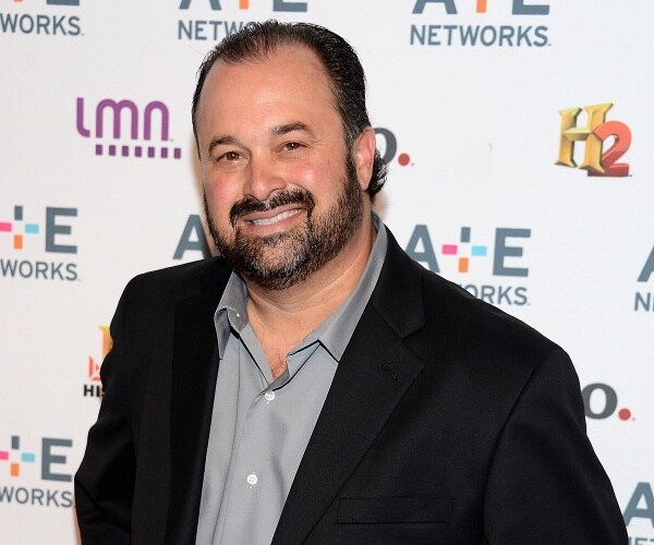 frank fritz stands on red carpet