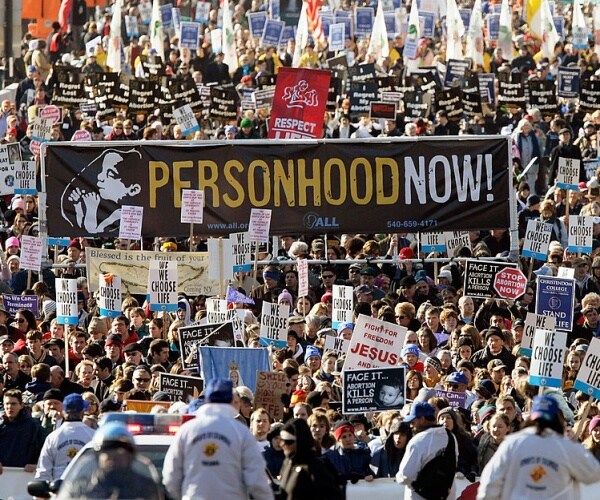 pro-life activists with signs participate in the annual march for life event