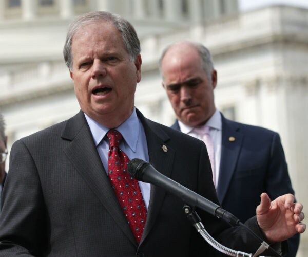 alabama sen, doug jones speaks at a news conference on capitol hill.