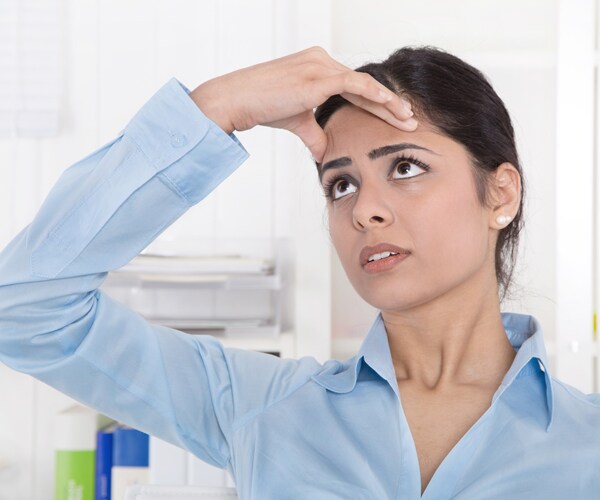 a woman suffering from a migraine headache