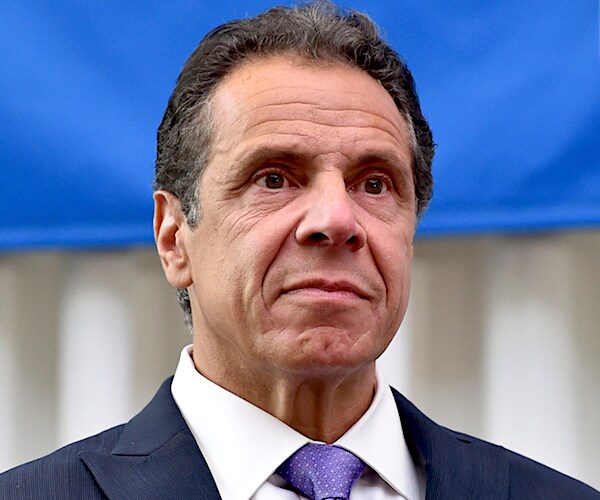 andrew cuomo speaks to the media with a contrite expression