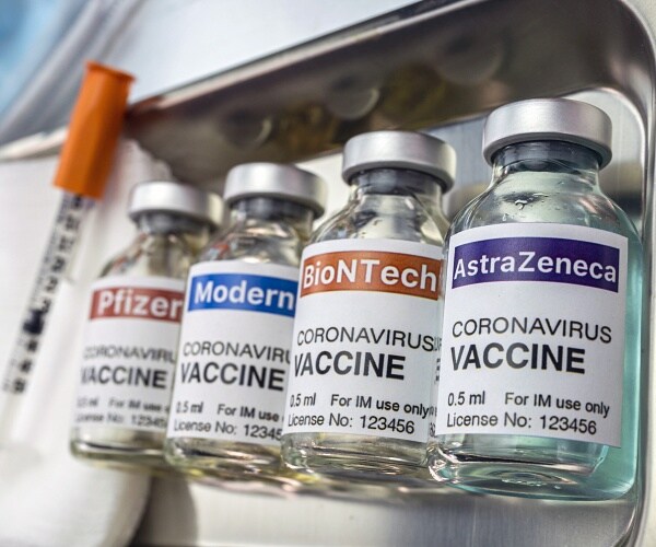 coronavirus vaccines in silver tray with needle