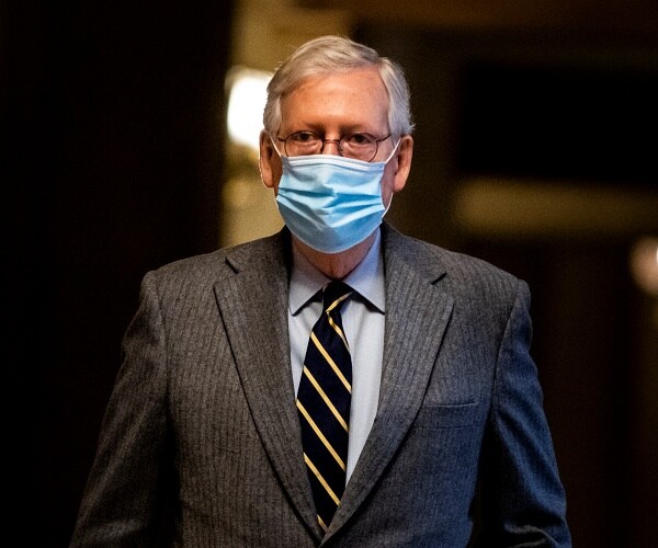 mitch mcconnell walks through the capitol building