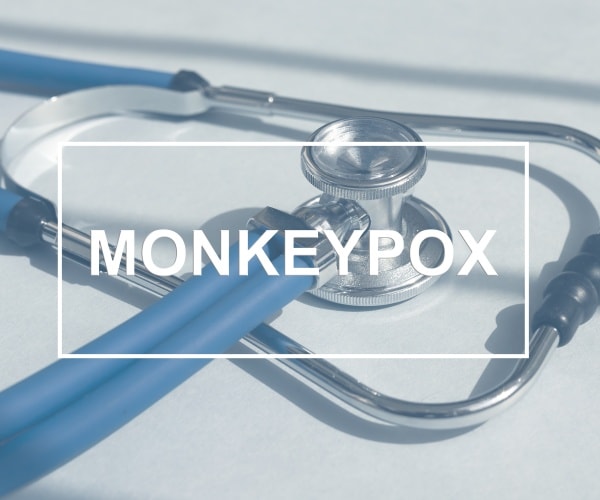 Monkeypox written in white block letters over stethoscope