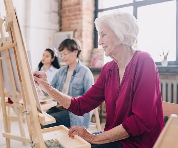 older woman in painting class