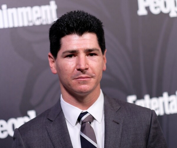 fishman in a gray suit and striped gray and black tie