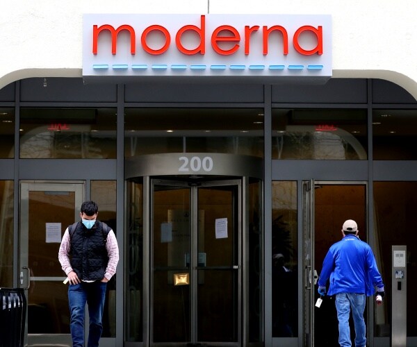moderna building is shown with people walking in and out