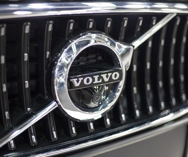 volvo logo is shown at the front of a car